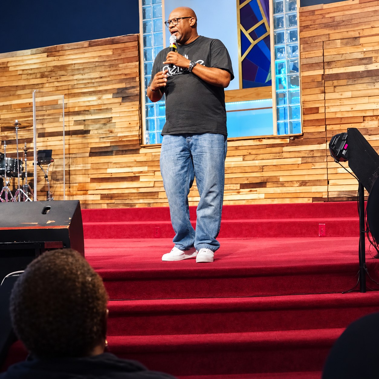 Pastor Stephen speaking with a microphone